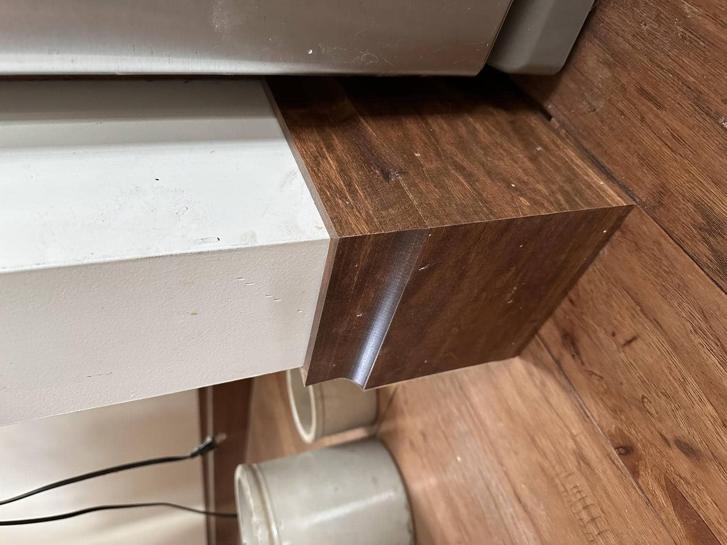 Tightly mitered stained baseboard corner by Bond Trim LLC